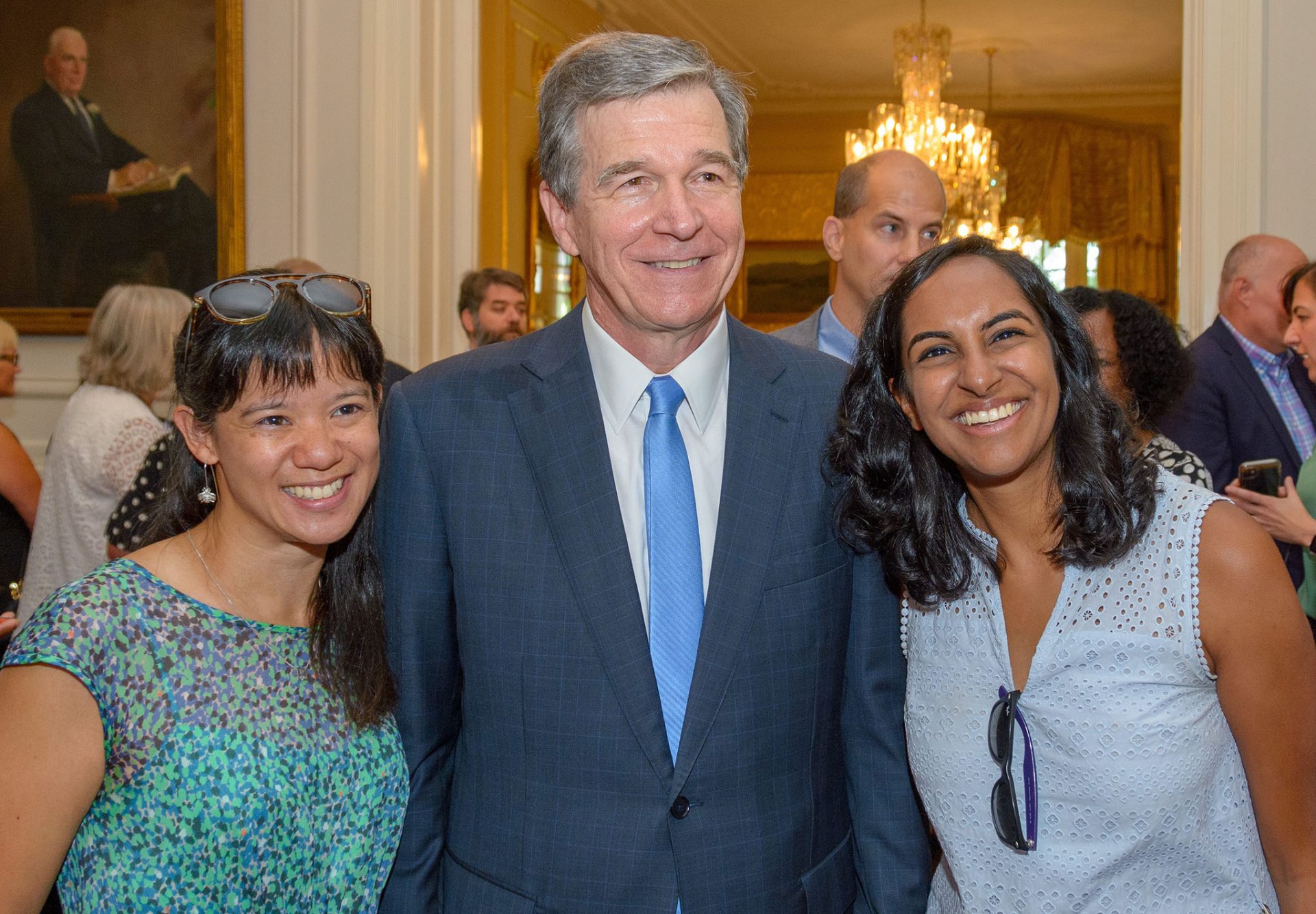 From left to right: Charlene Wong ’04, North Carolina Governor Roy Cooper ’79, and Madhu Vulimiri ’14.