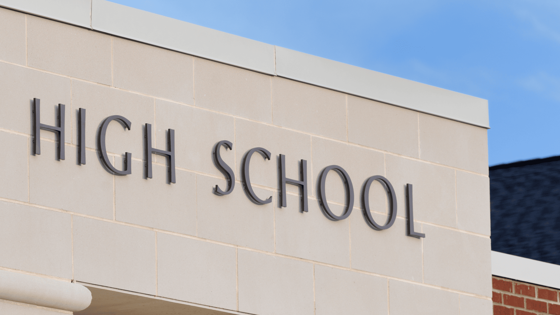 A high school building with a prominent sign displaying the name of the institution.