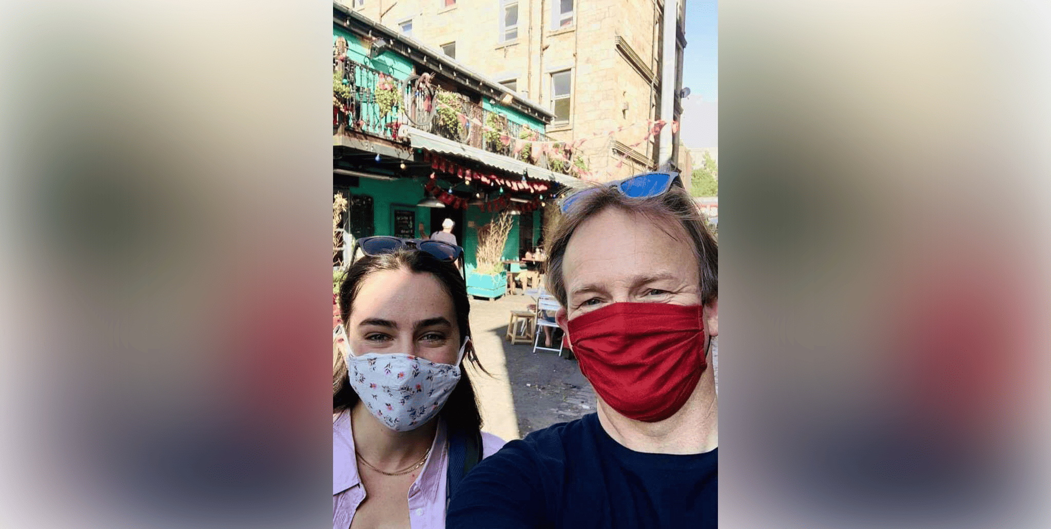 Two masked people pose for a selfie in Glasgow, Ireland.