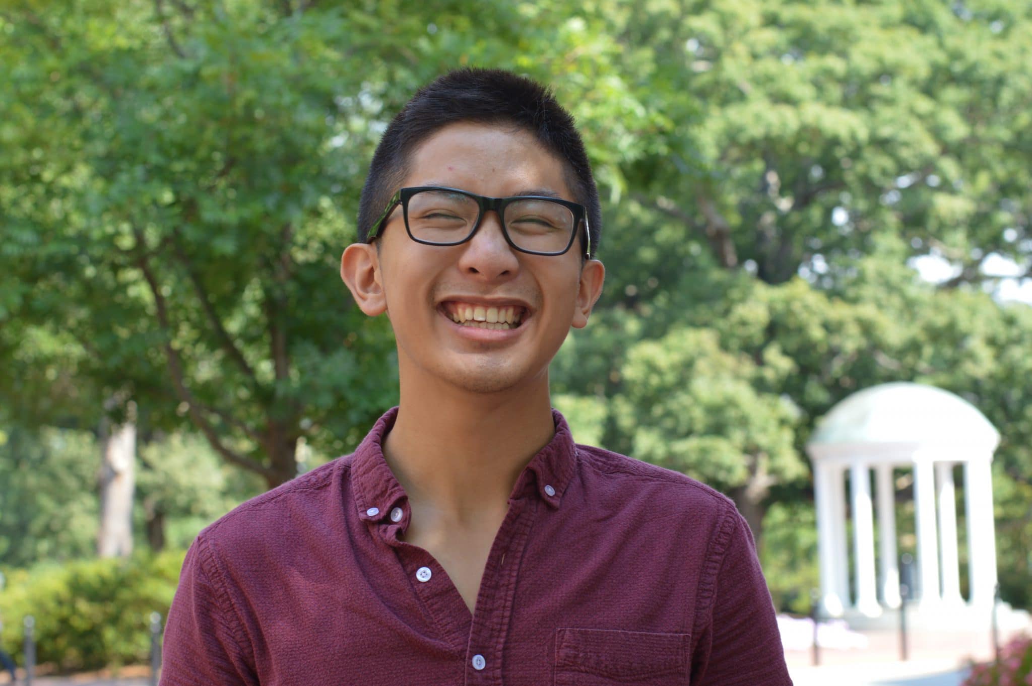 Raymond Tu in glasses smiling.
