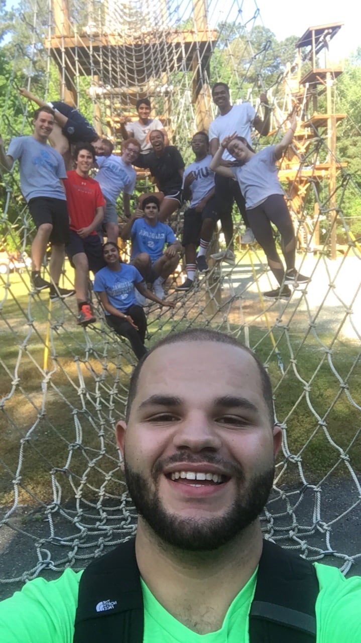 Taner with a group of students smiling.