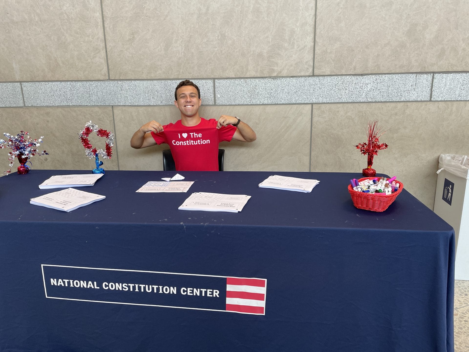 Justin Goldman ’25 behind working at an information table for the National Constitution Center