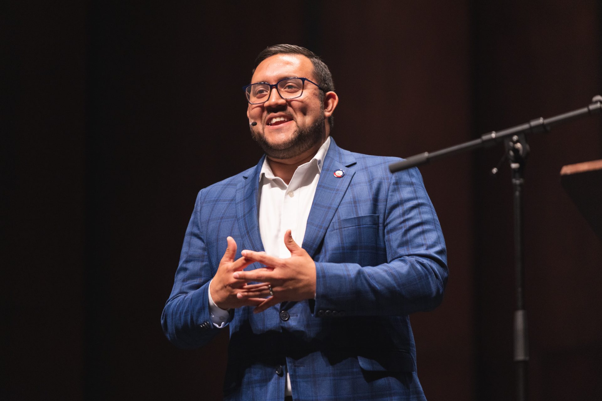 Ricky Hurtado ’11 smiles at the audience from onstage.