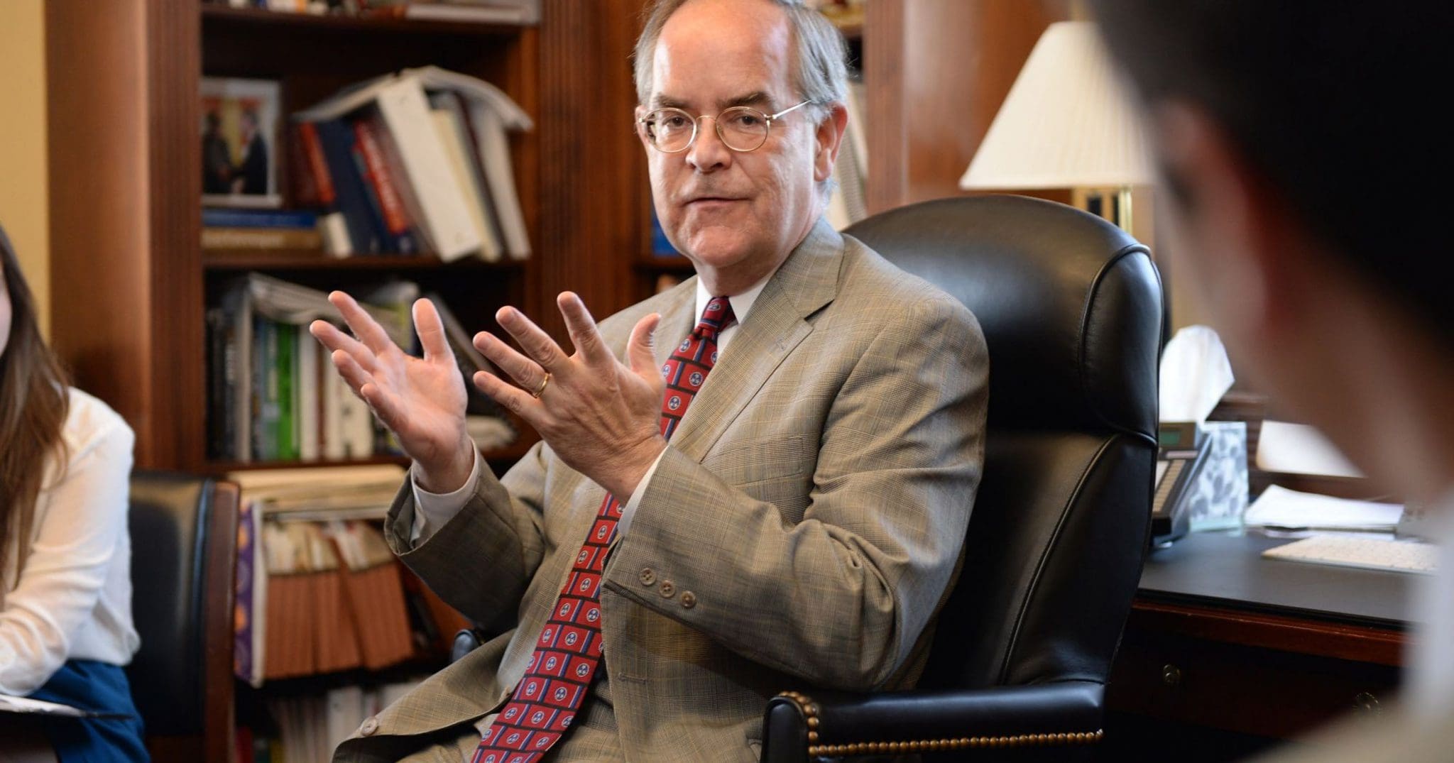 Jim Cooper in an office speaking with a group of people.