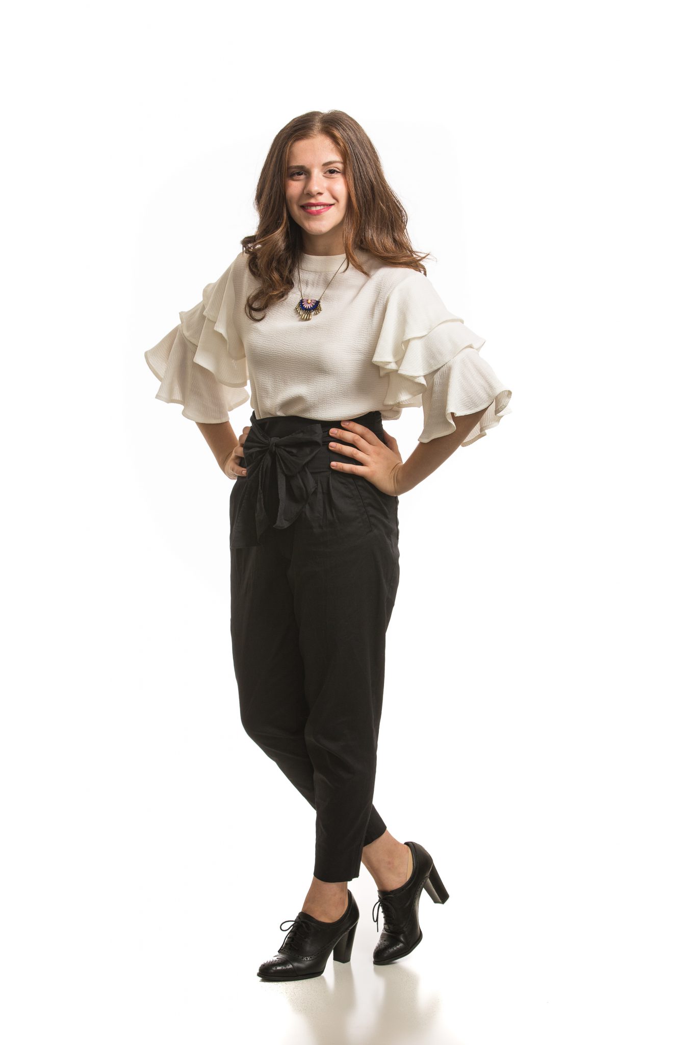Sandy smiling with her hands on her hips.