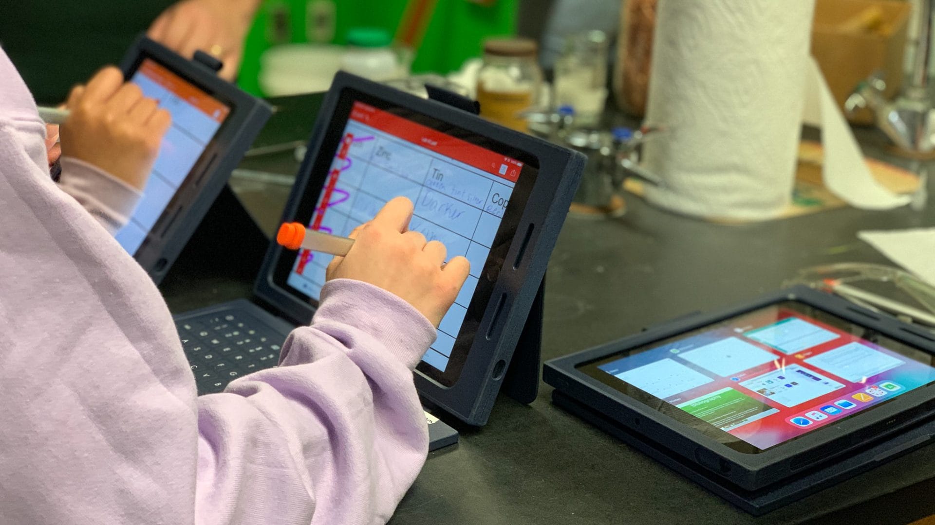 Students work on an Apple device in chemistry class.