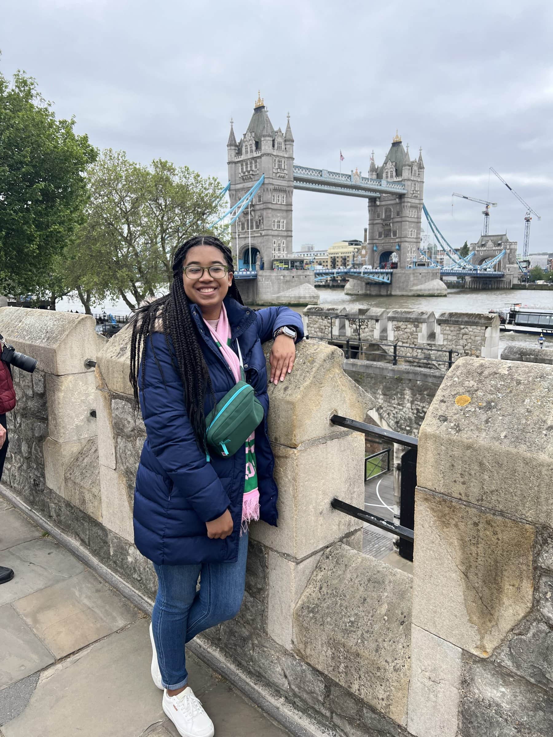 Person standing in front of bridge