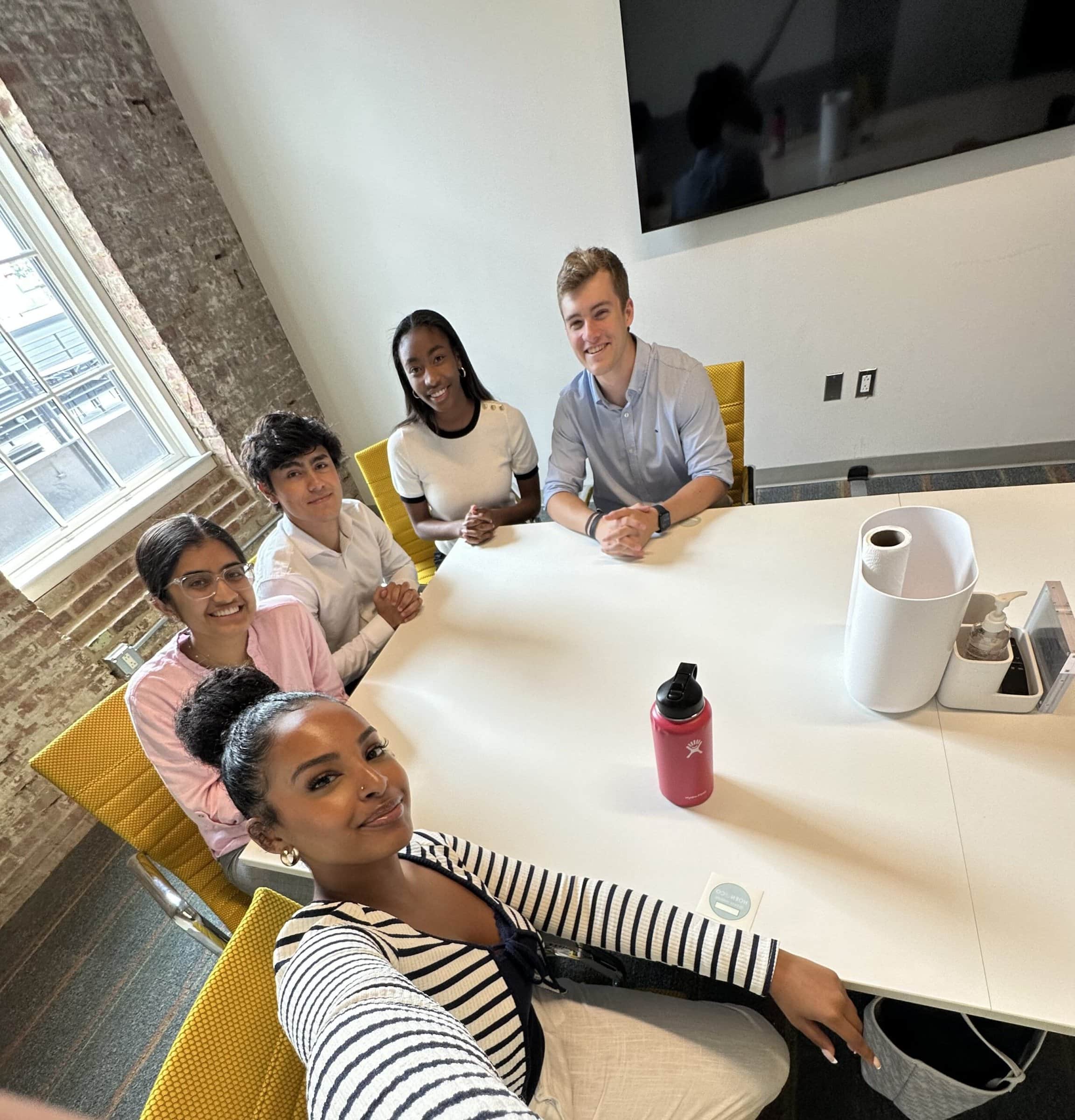 A diverse group of professionals having a meeting around a table in an office setting.