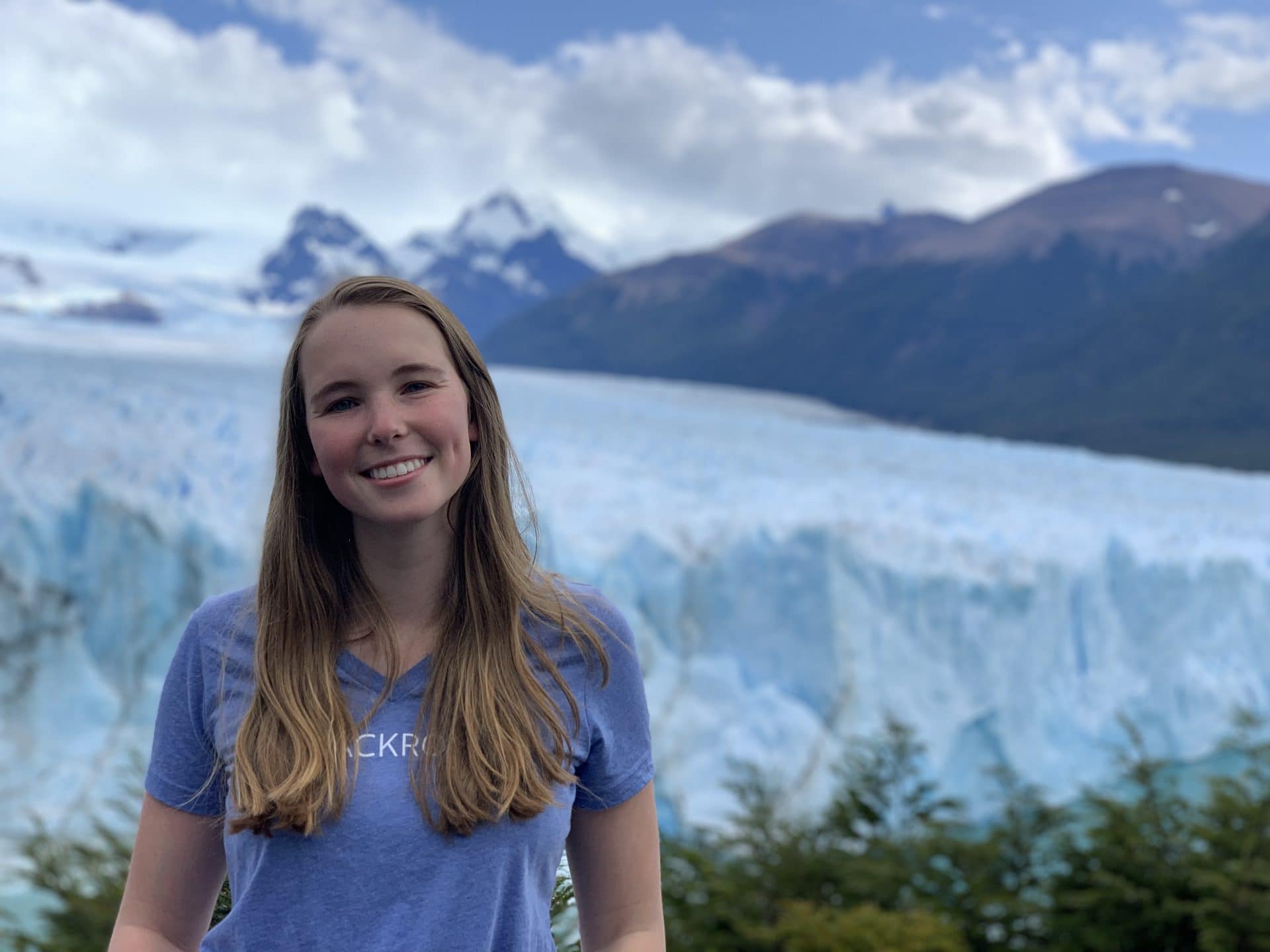 Ashley stands in front of icy mountains.