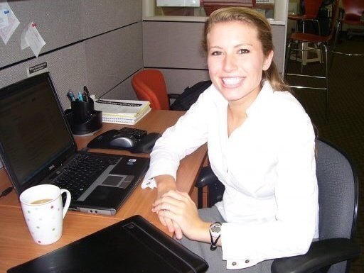 Hadley sitting at desk smiling.