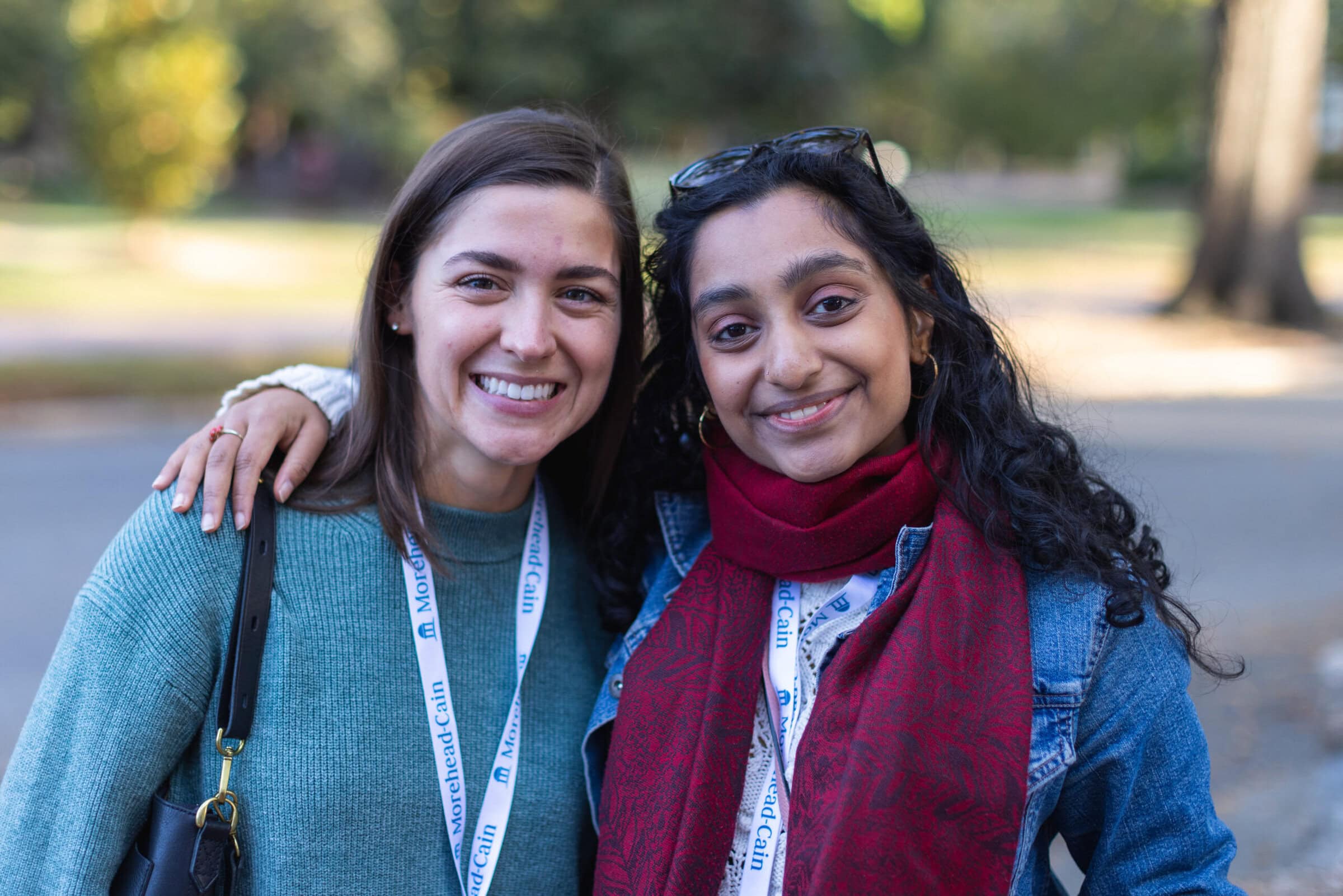 Photo of two women side-by-side smiling.