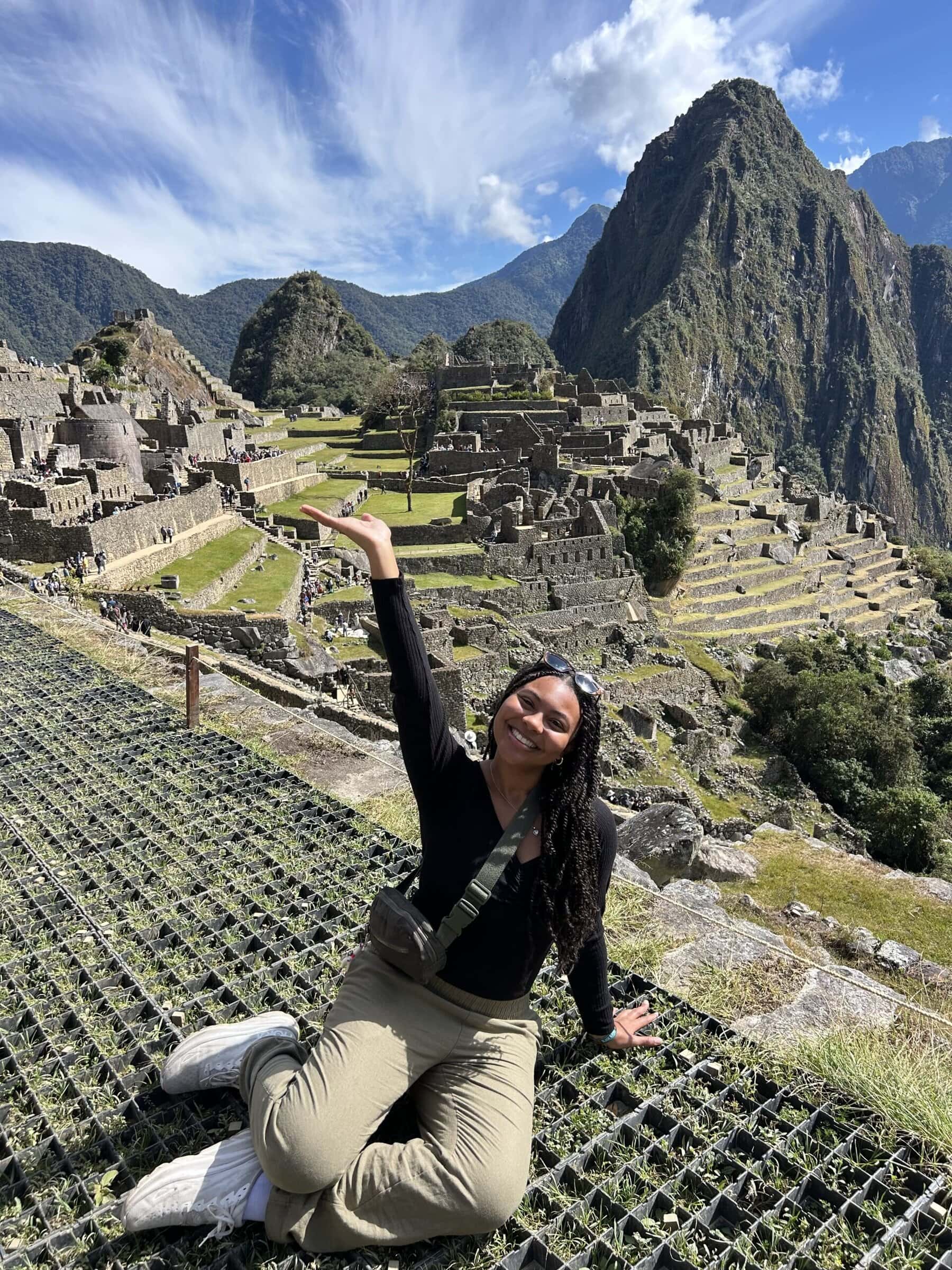 A scholar posing in front of Machu Picchu