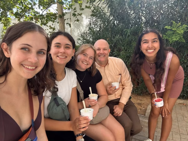 Four global gap year scholars and Ousley Naseman pose together outdoors in Athens, Greece, holding ice cream.