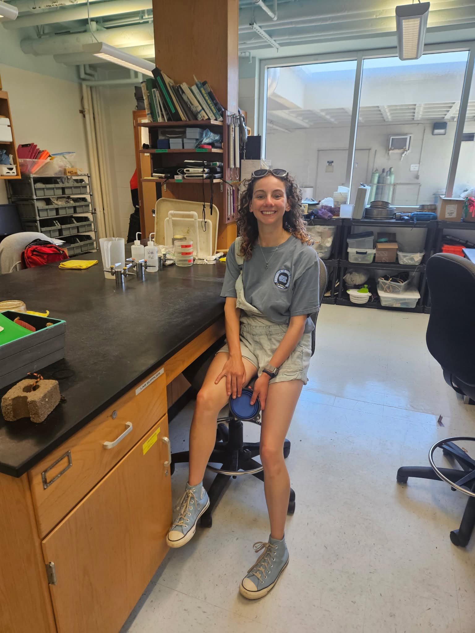 Alexandra Newmark ’27 sits at a desk in the Fodrie Estuarine Ecology Lab at the UNC Institute of Marine Sciences in Morehead City, North Carolina.