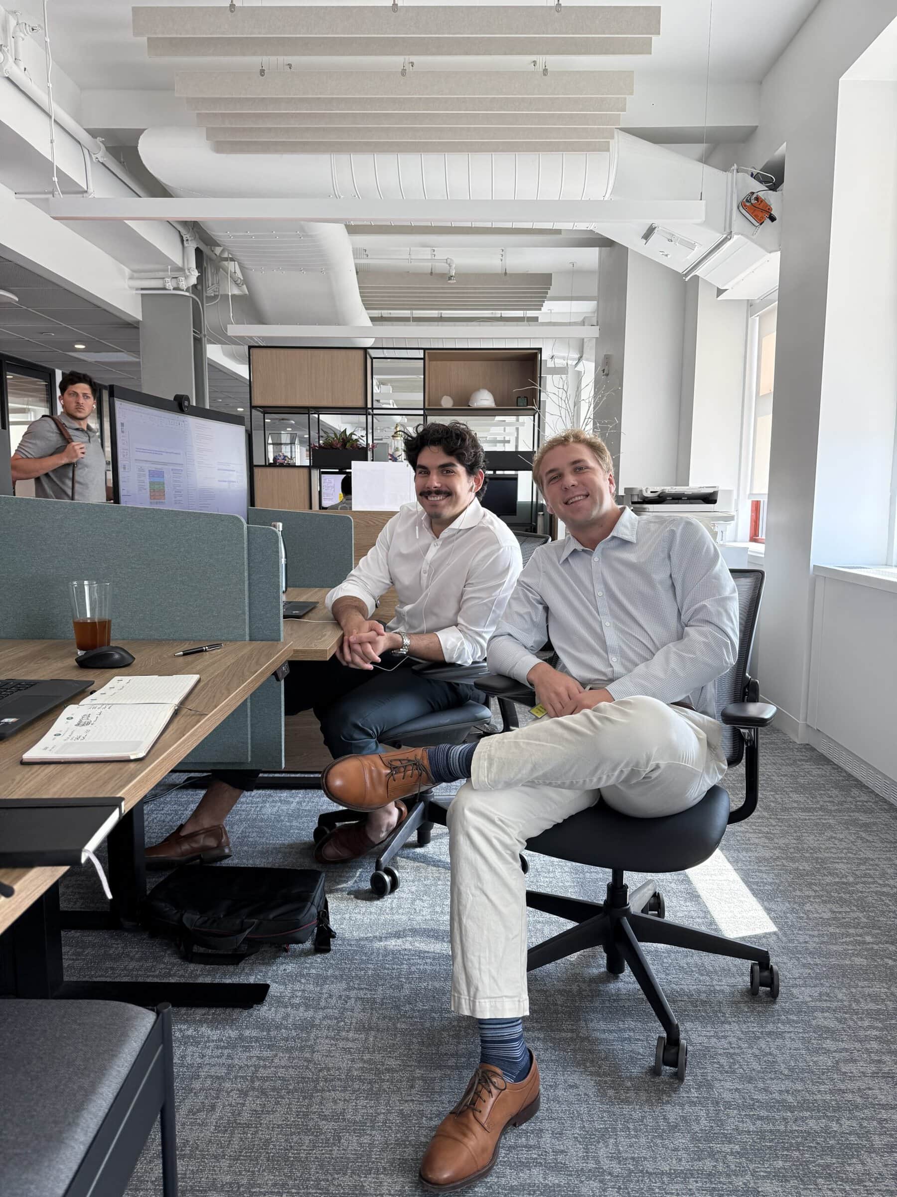 Benji Garland ’27 and John, an MBA intern, sit together in Kearney’s New York City office at the Empire State Building.