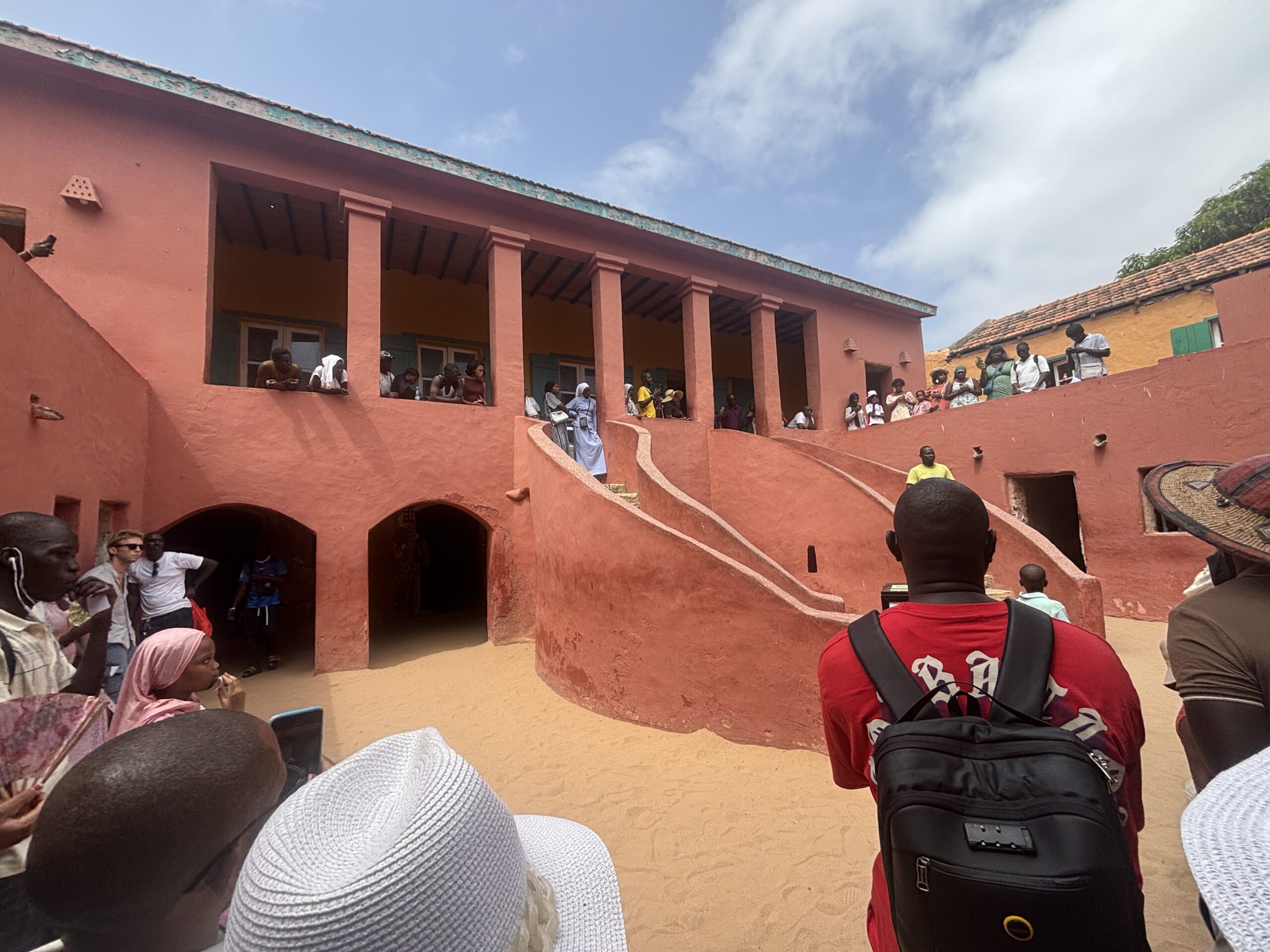 People stand outside the Maison des Esclaves on Gorée Island, off the coast of Dakar, Senegal.